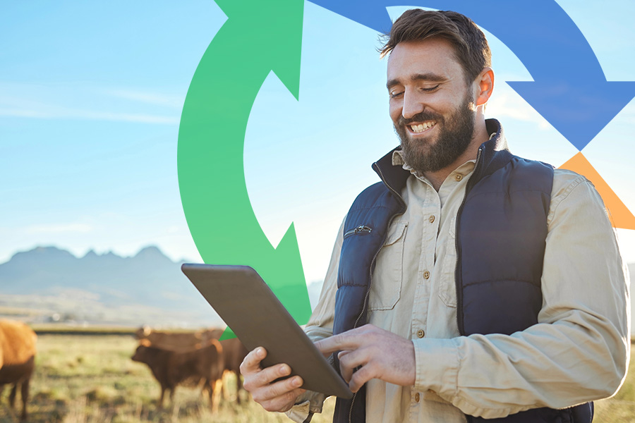 Happy farmer outside by his cow pastor uses a tablet with a Conexon icon in the background for thumbnail.