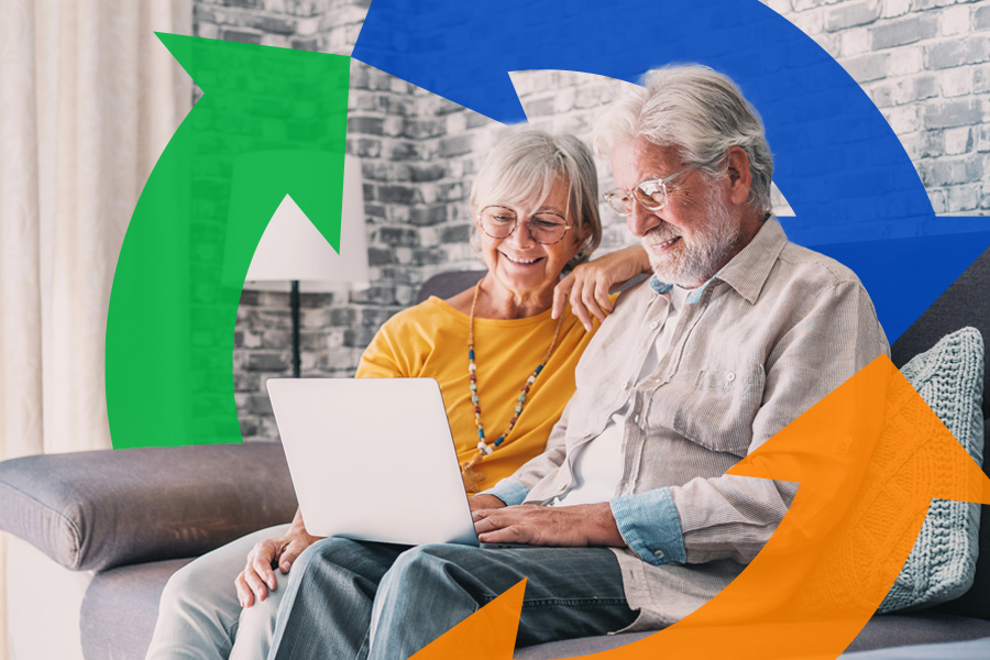 Elderly couple smiles and looks at their computer with a Conexon Connect icon in background.
