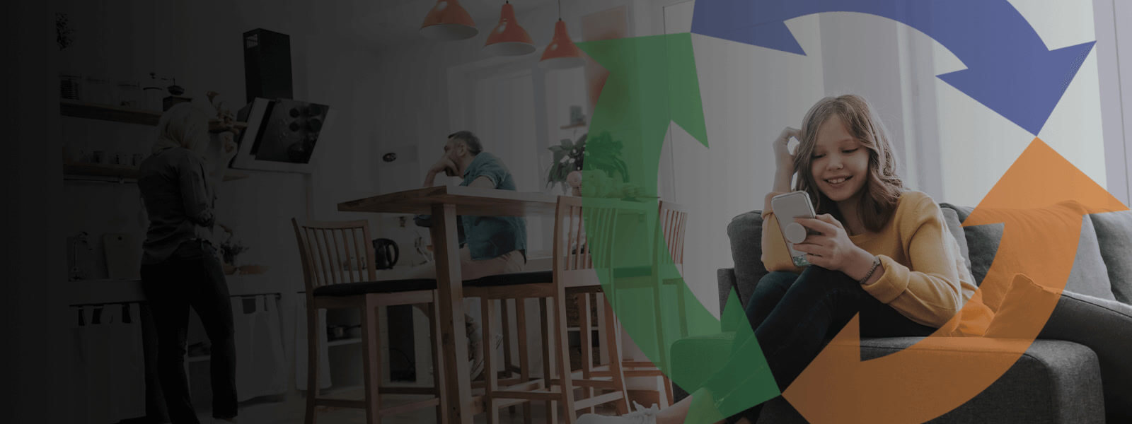 young girl sits on her couch using a smart phone and smiling.